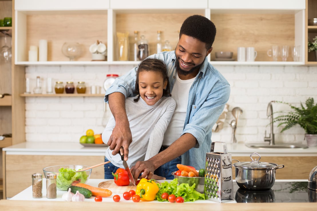 Vegan family cooking healthy food together at home